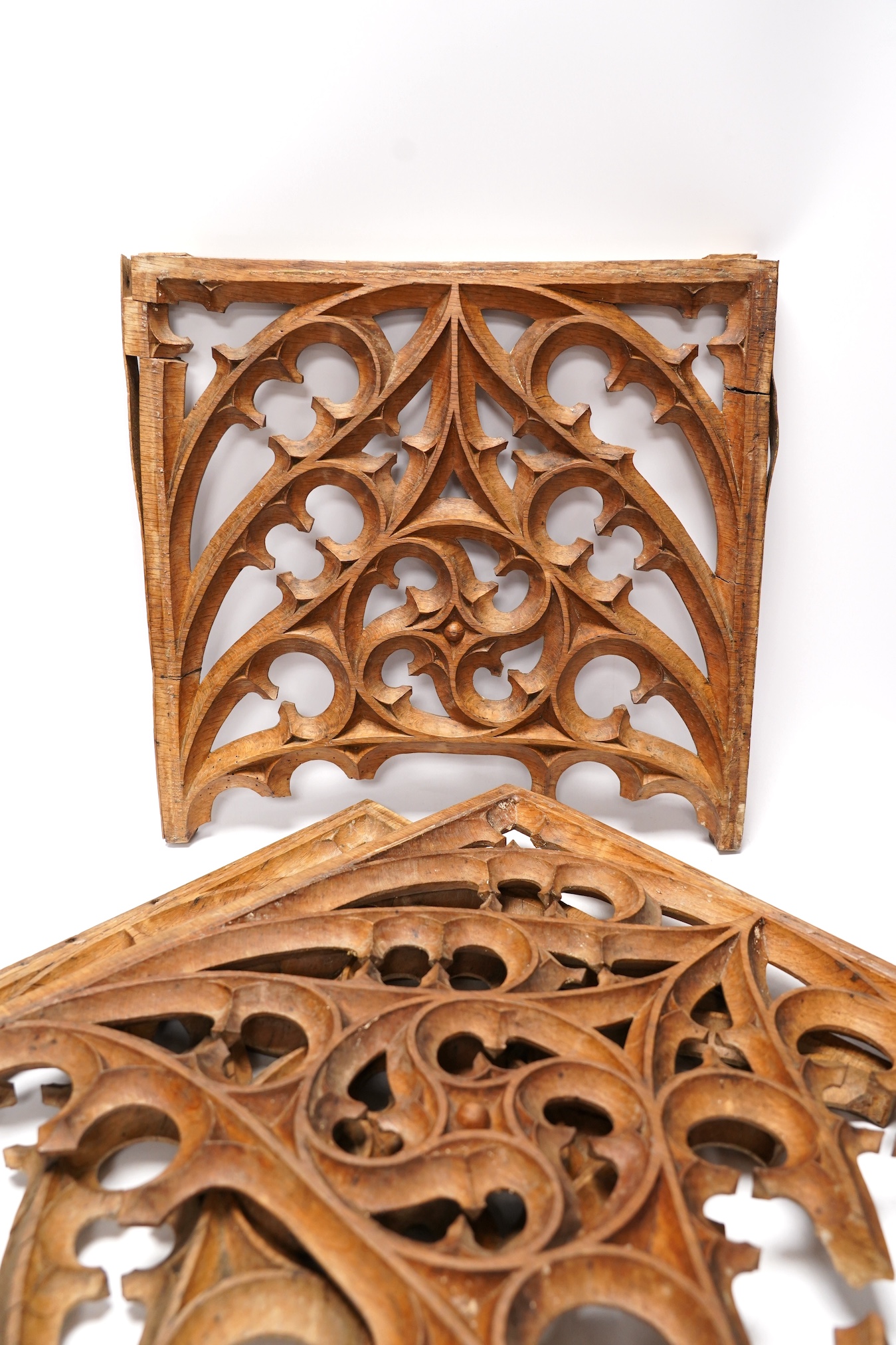 A set of three Victorian or earlier gothic carved oak tracery panels, 37cm high. Condition - fair to poor, losses and cracking